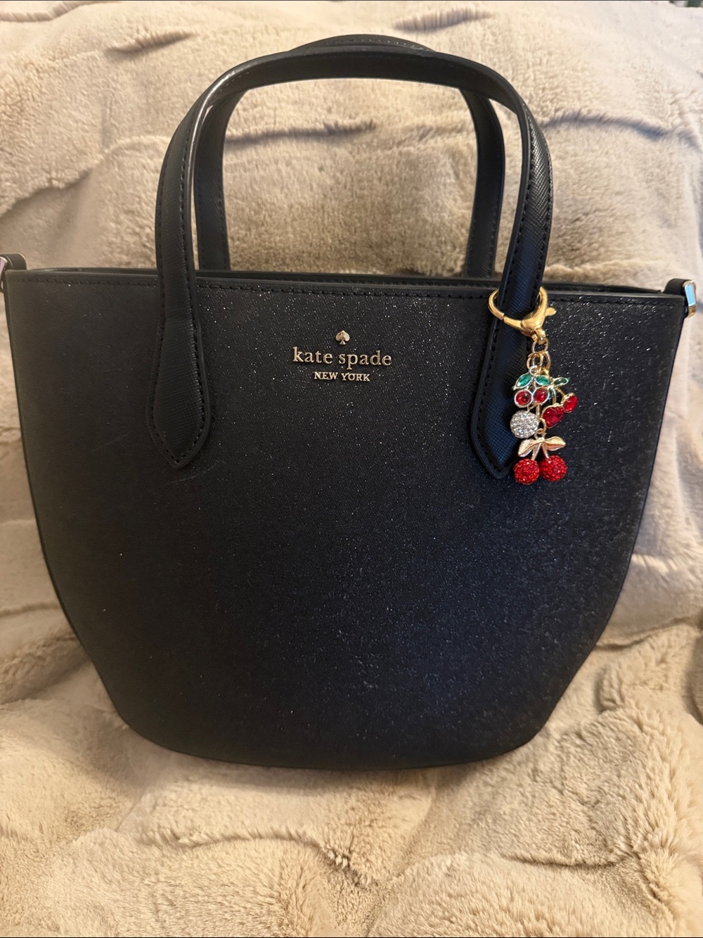 kate spade black crossbody tote with gold logo and cherry charm